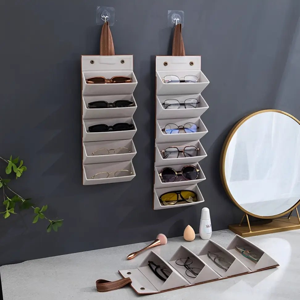 Organizador de óculos dobrável e compacto posicionado sobre mala de viagem, ideal para transporte seguro e discreto